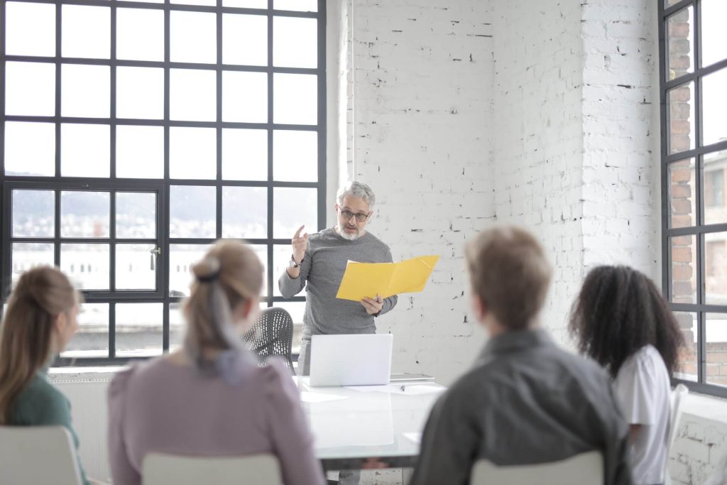 Male Boss Speaking To Multiracial Colleagues At Conference 1024x683 1